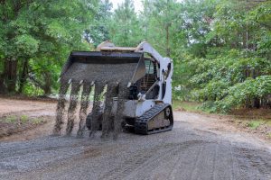 skid steer the bobcat tractor moves and unloads gravel 1920